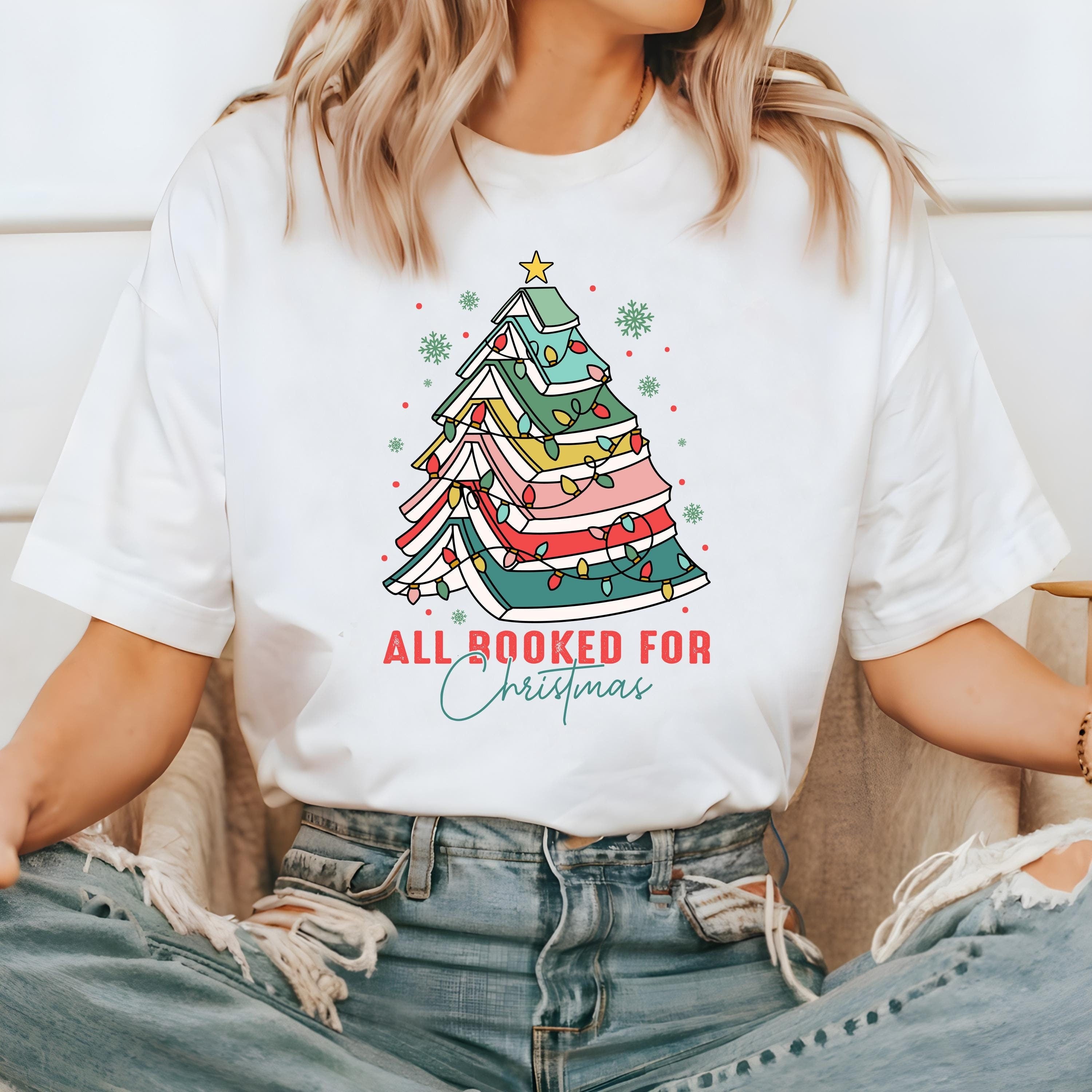 Christmas tree made of books with Christmas lights wrapped around it.