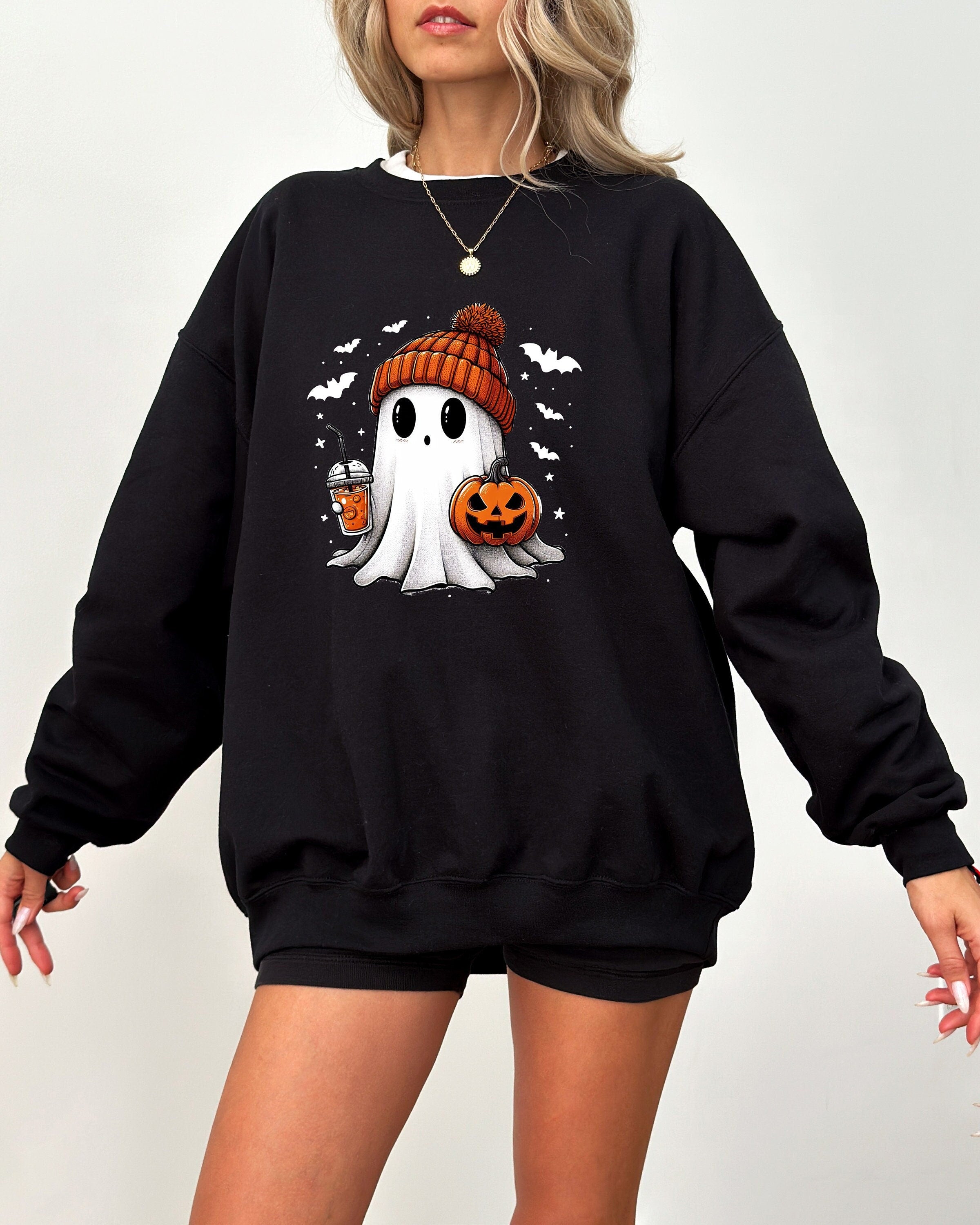 Black Crew Neck Sweatshirt, Cute Ghost Design wearing a beanie, holding an iced coffee and a jack o lantern, Bats flying