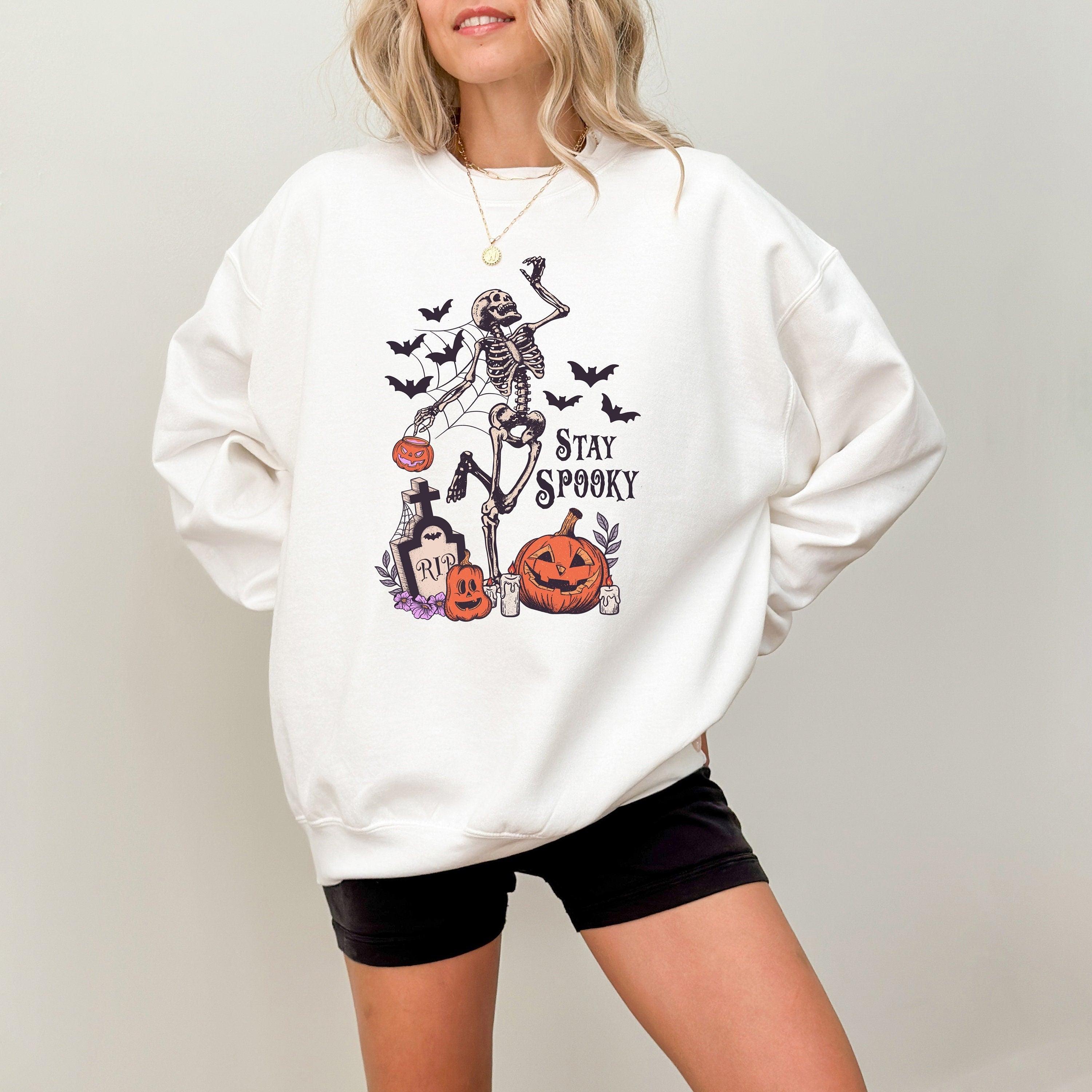 Dancing Skeleton with jack o lantern design with bats and a spider web